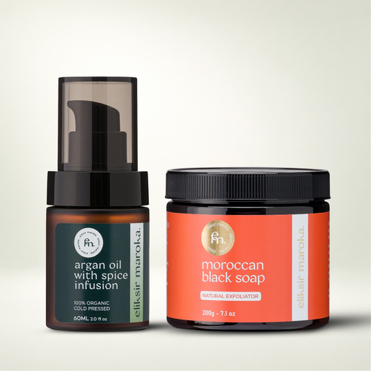Two dark glass containers: argan oil with spice infusion pump bottle and a jar of eliksir maroka Moroccan black soap.